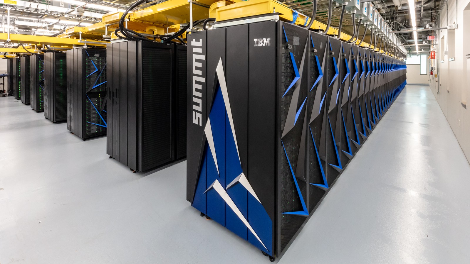 Rows of cabinets inside a large supercomputer facility