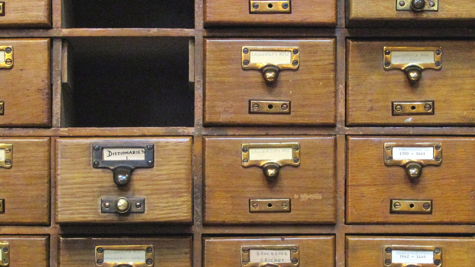 Rows of labelled wooden card catalogue drawers, several of them blank